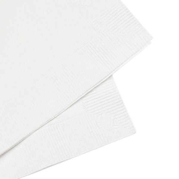White paper napkins with embossed border and crest detail.