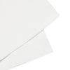 White paper napkins with embossed border and crest detail.