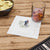 Personalized cocktail napkin with couple's initials and humorous quote.